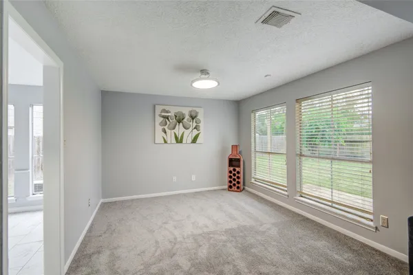a kitchen with granite countertop white cabinets sink and window