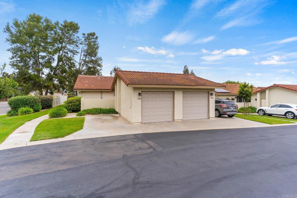 a view of a house with a yard and garage