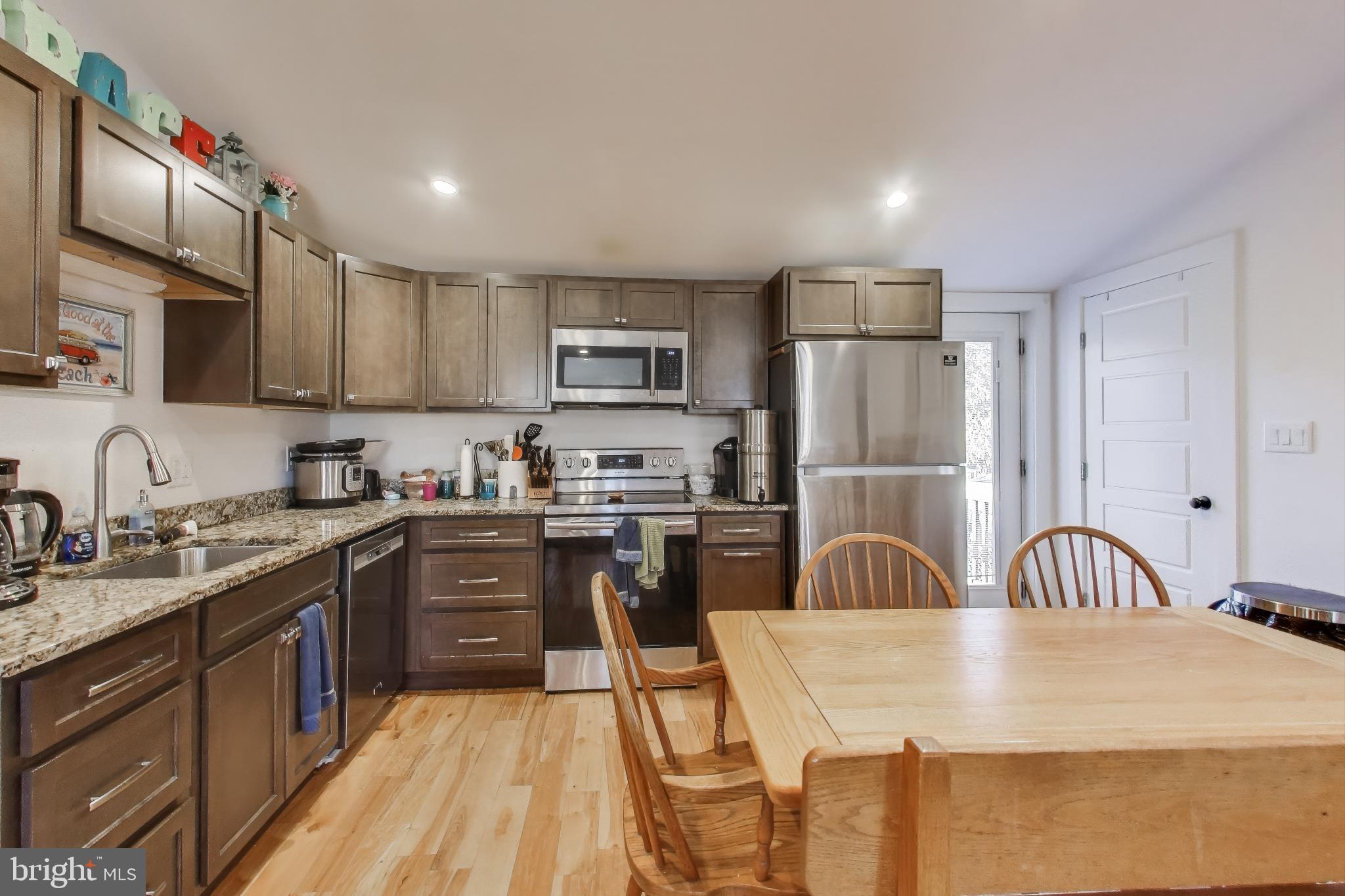 8238 WB&A Road Severn, MD 21144 - Photo 7 of 23 a kitchen with granite countertop a sink stainless steel appliances and cabinets