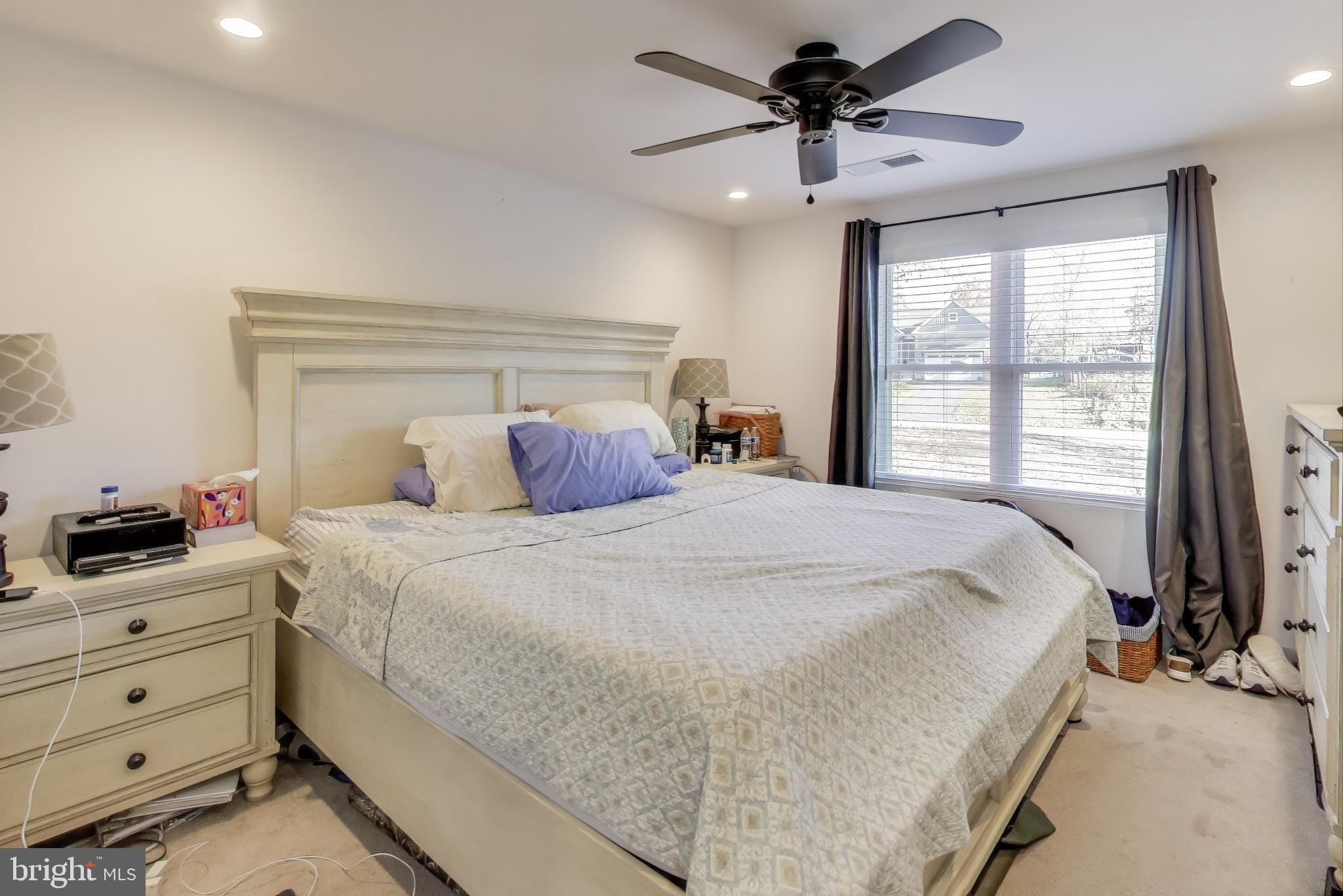 8238 WB&A Road Severn, MD 21144 - Photo 10 of 23 a bedroom with a large bed and a chandelier