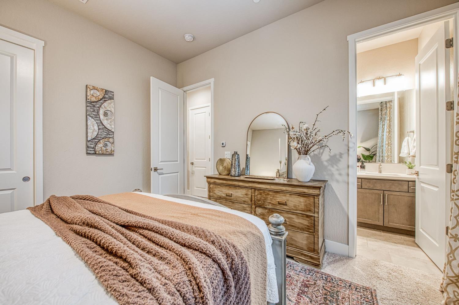 993 Ridgeline Road Madera, CA 93636 - Photo 40 of 84 a bedroom with a large bed and a chandelier