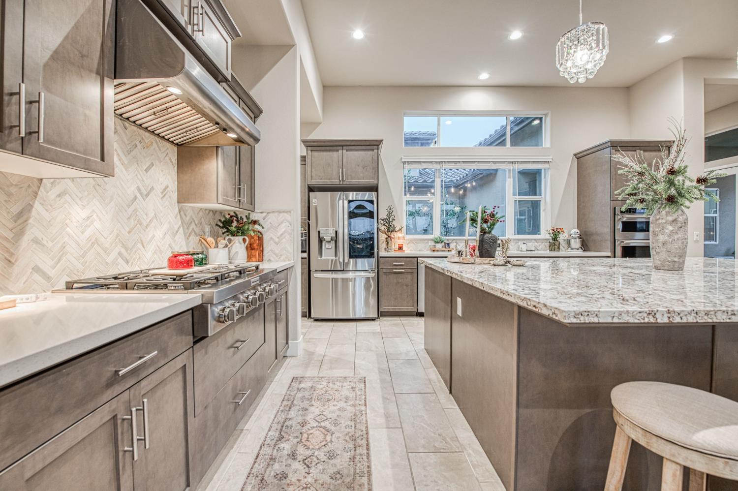 993 Ridgeline Road Madera, CA 93636 - Photo 54 of 84 a kitchen with stainless steel appliances granite countertop a sink and cabinets