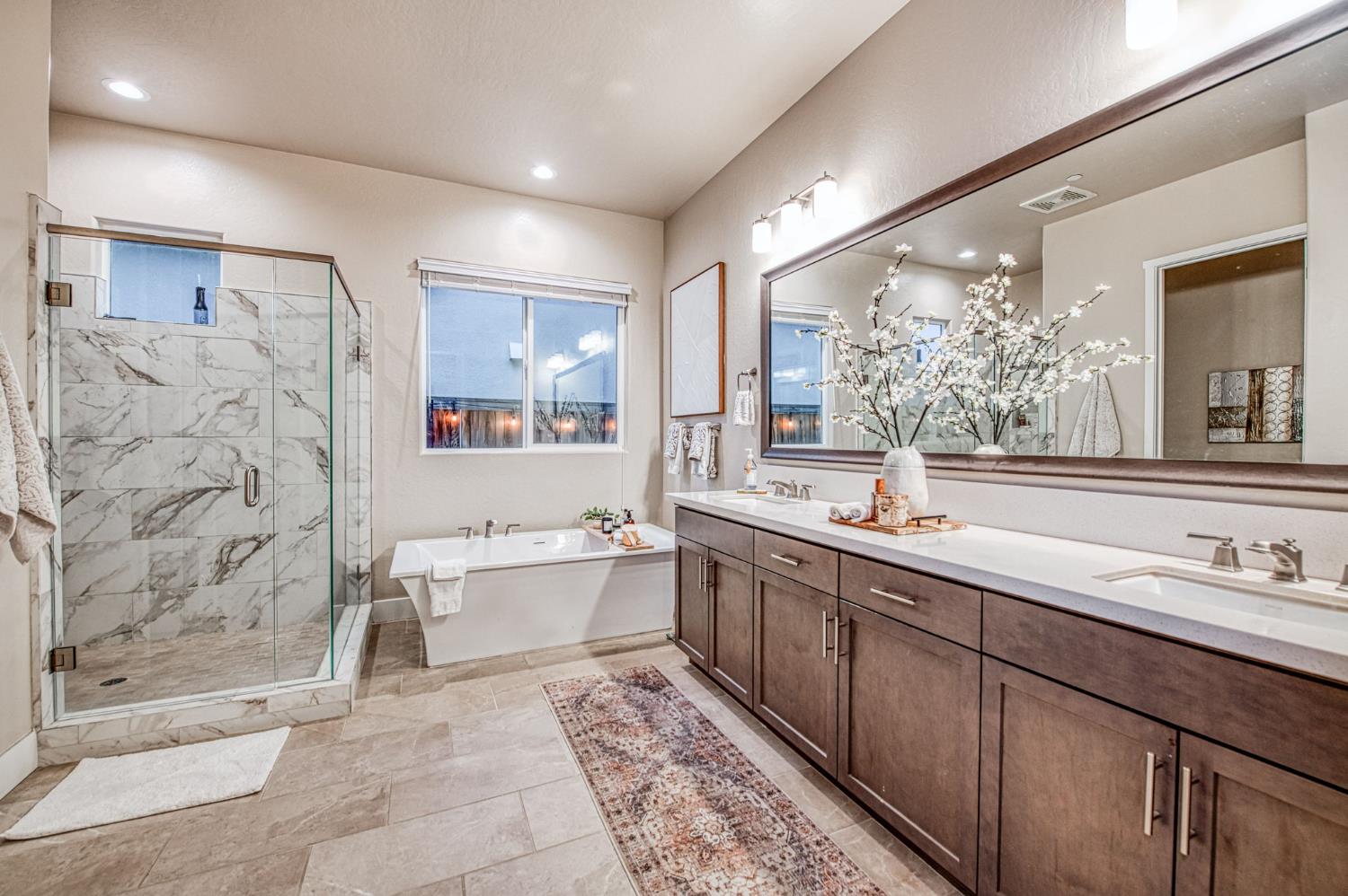 993 Ridgeline Road Madera, CA 93636 - Photo 72 of 84 a spacious bathroom with a double vanity sink mirror and bathtub