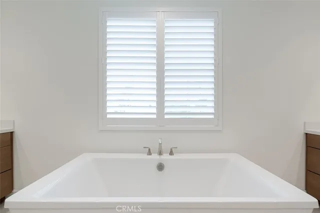 a white bath tub sitting next to a window