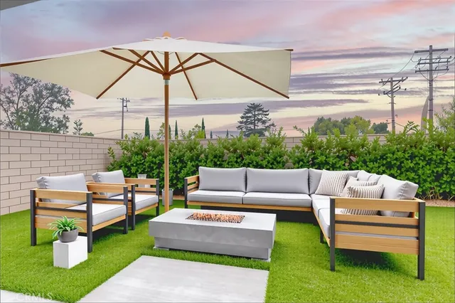 a view of a patio with couches and a table and chairs with the ocean view