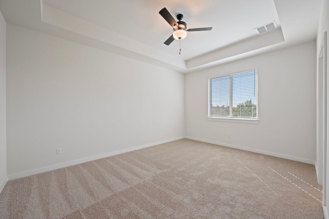 2600 Gattis School Road, Unit 1203 Round Rock, TX 78664 - Photo 13 of 25 Empty room with a raised ceiling and carpet