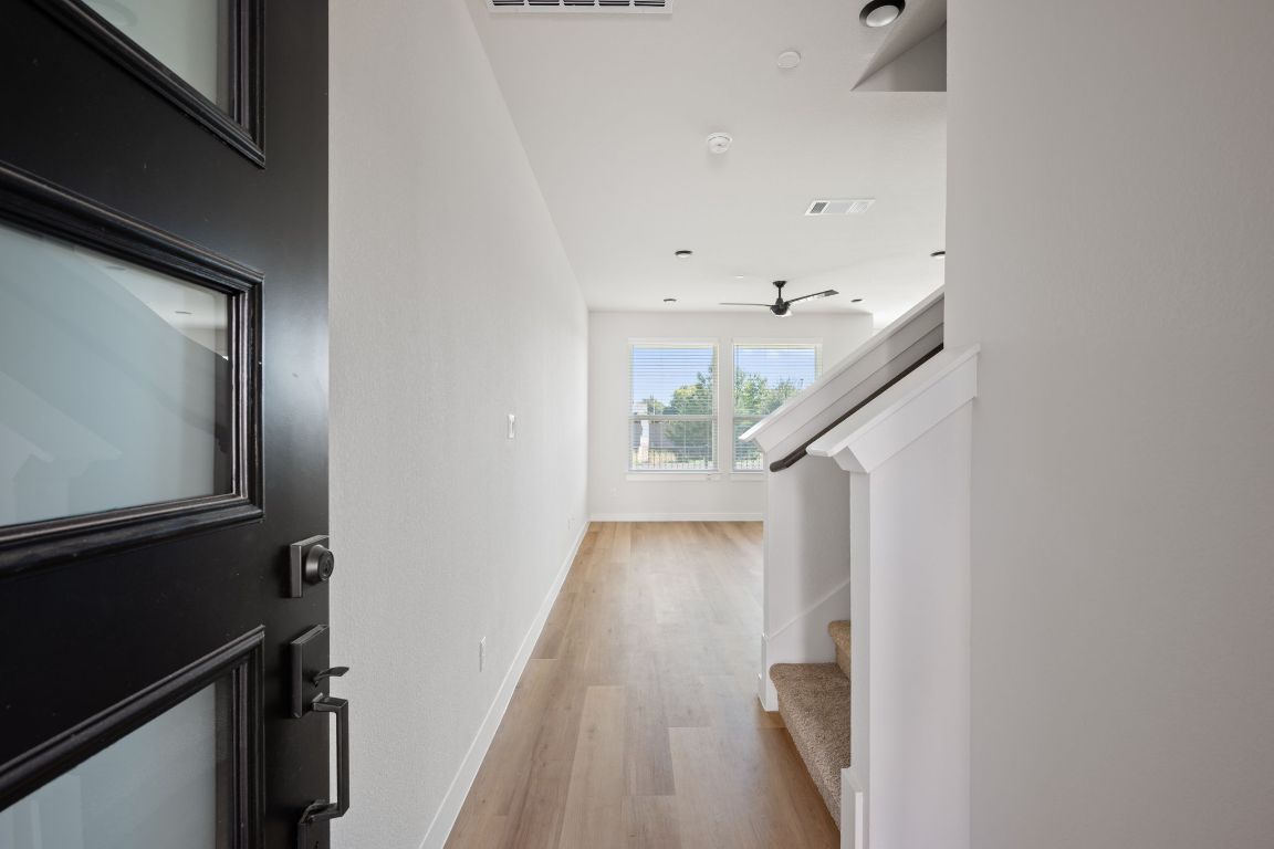 2600 Gattis School Road, Unit 1203 Round Rock, TX 78664 - Photo 2 of 25 Hallway with stairway and light wood-style floors