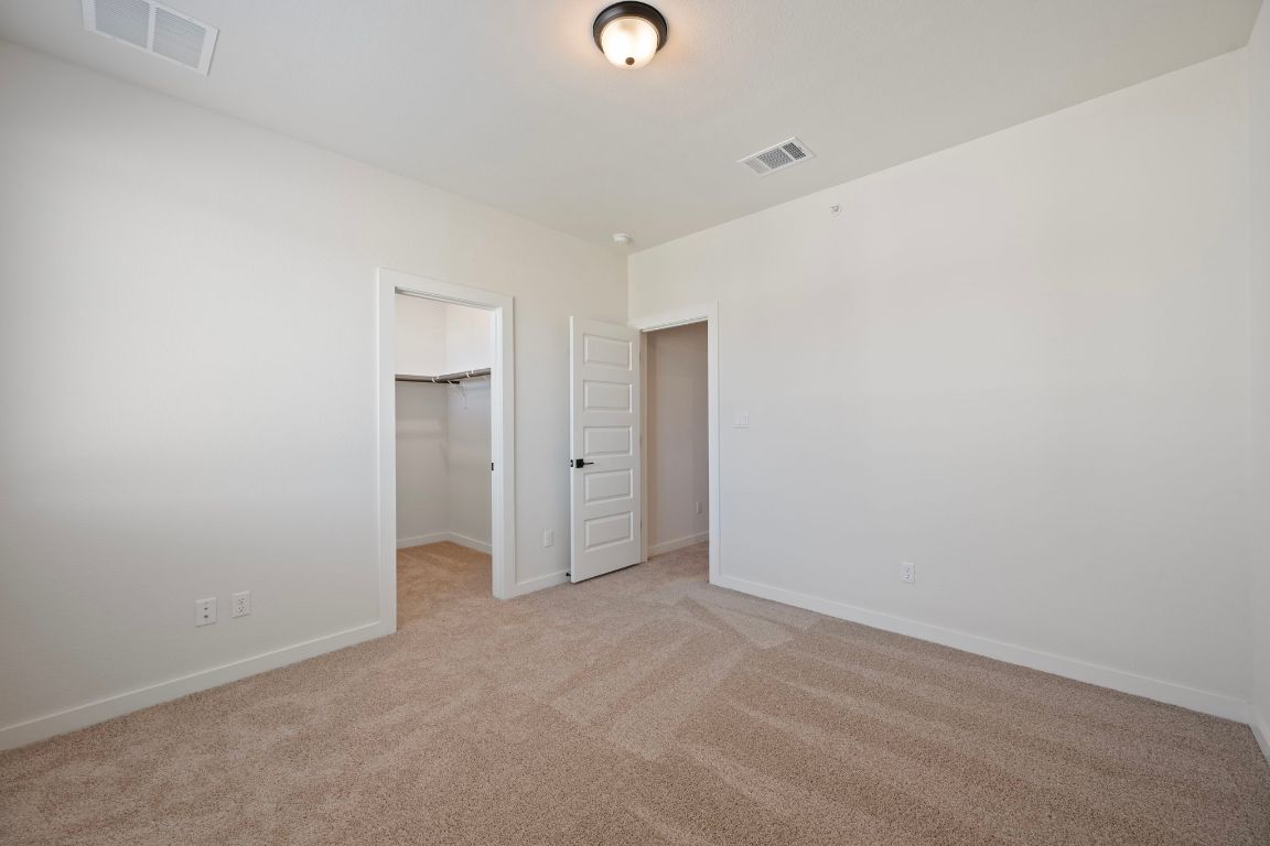 2600 Gattis School Road, Unit 1203 Round Rock, TX 78664 - Photo 21 of 25 Unfurnished bedroom featuring a spacious closet and light carpet