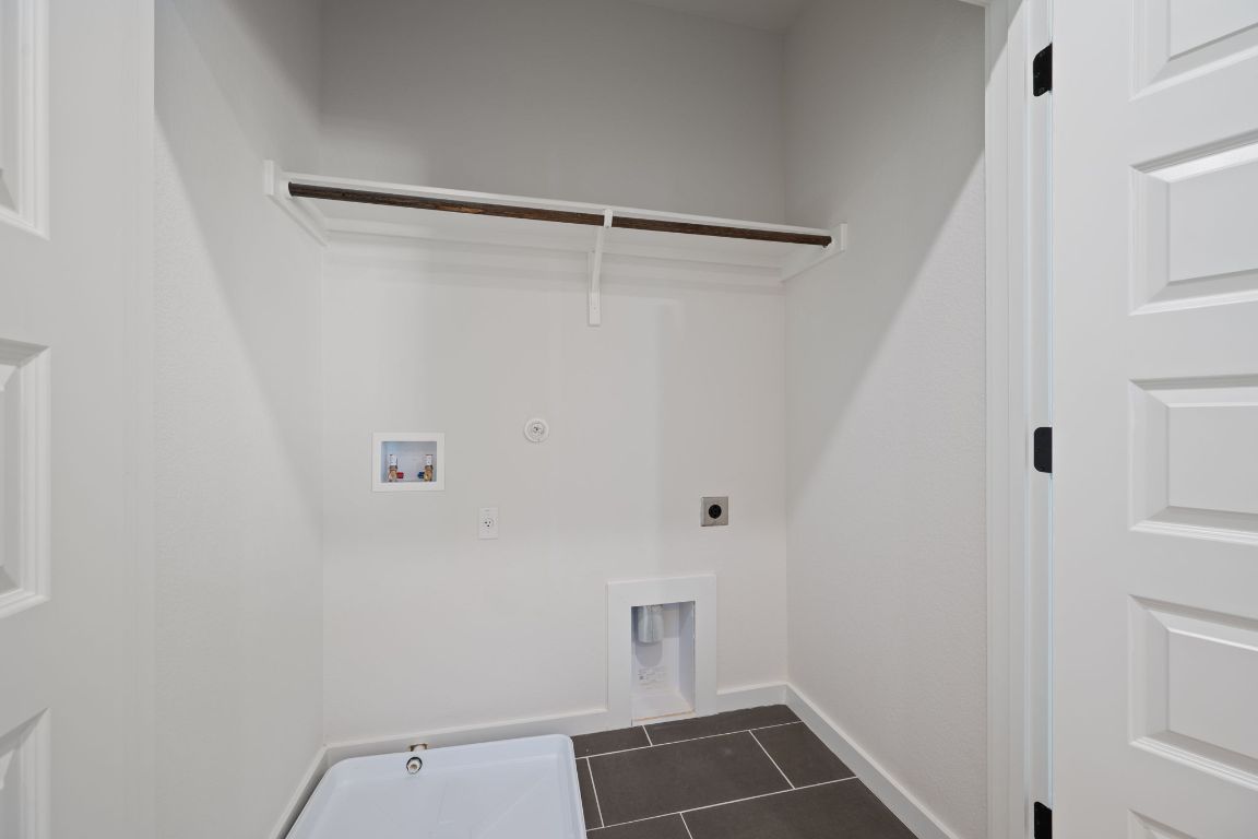 2600 Gattis School Road, Unit 1203 Round Rock, TX 78664 - Photo 22 of 25 Laundry room with hookup for a gas dryer, dark tile patterned floors, hookup for a washing machine, and electric dryer hookup