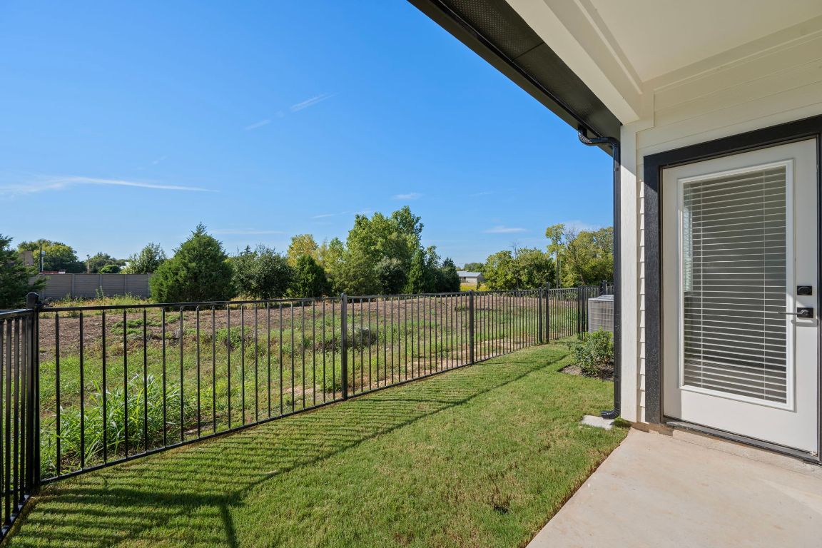 2600 Gattis School Road, Unit 1203 Round Rock, TX 78664 - Photo 23 of 25 Fenced backyard featuring a patio area