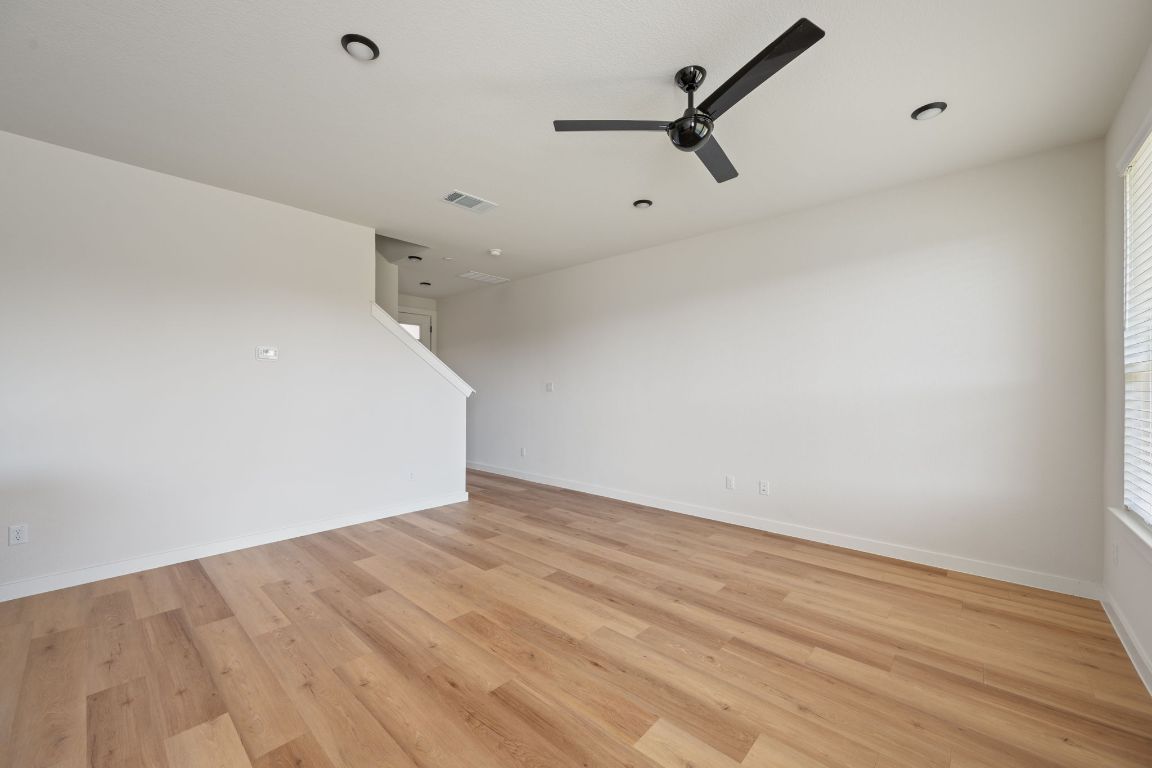 2600 Gattis School Road, Unit 1203 Round Rock, TX 78664 - Photo 4 of 25 Unfurnished living room with light wood-type flooring and ceiling fan