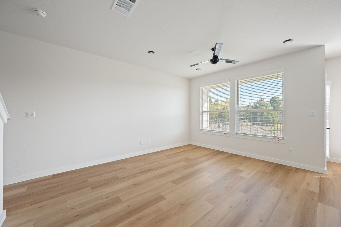 2600 Gattis School Road, Unit 1203 Round Rock, TX 78664 - Photo 5 of 25 Empty room with light wood-style flooring and a ceiling fan