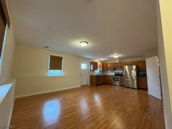 a view of a livingroom with furniture and a wooden floor