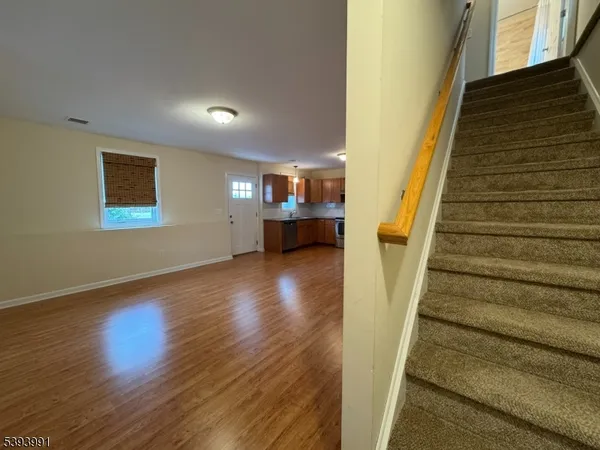 a view of entryway and hall with wooden floor
