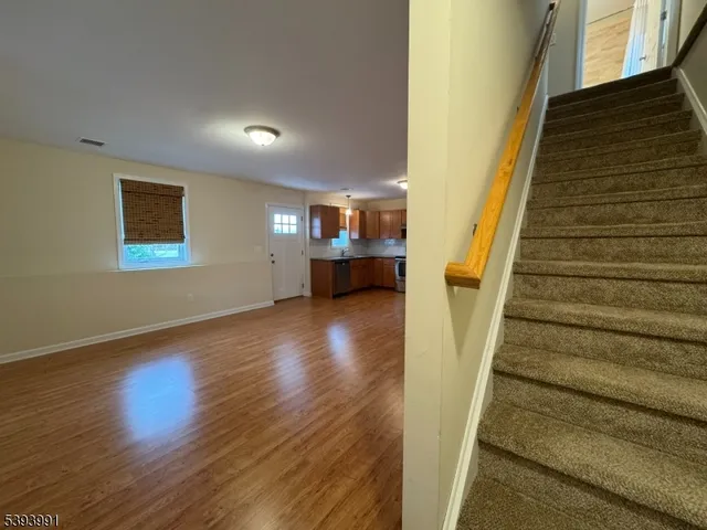 a view of entryway and hall with wooden floor