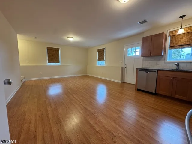 a view of a kitchen counter space and wooden floor