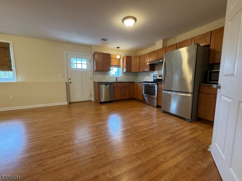 85 Highway 206, Unit B Augusta, NJ 07822 - Photo 10 of 42 a kitchen with stainless steel appliances wooden floor and large window