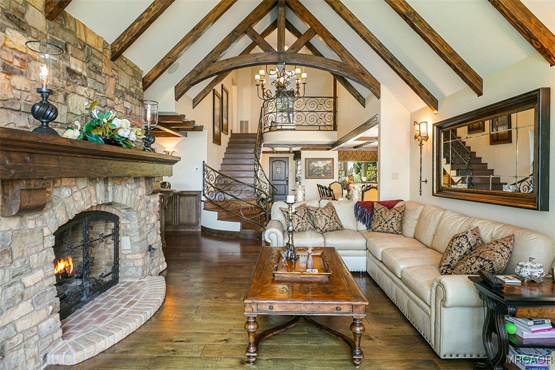 28087 North Shore Road Lake Arrowhead, CA 92352 - Photo 3 of 48 a living room with furniture a fireplace and a floor to ceiling window
