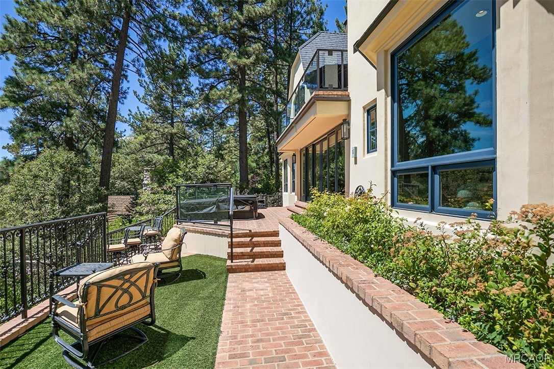 28087 North Shore Road Lake Arrowhead, CA 92352 - Photo 34 of 48 a view of house with backyard outdoor seating and plants