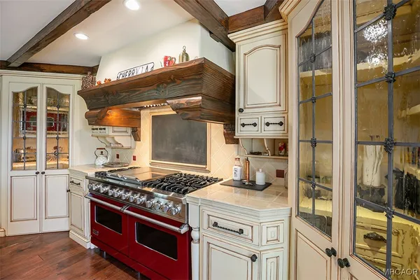 a kitchen with stainless steel appliances granite countertop a stove and cabinets