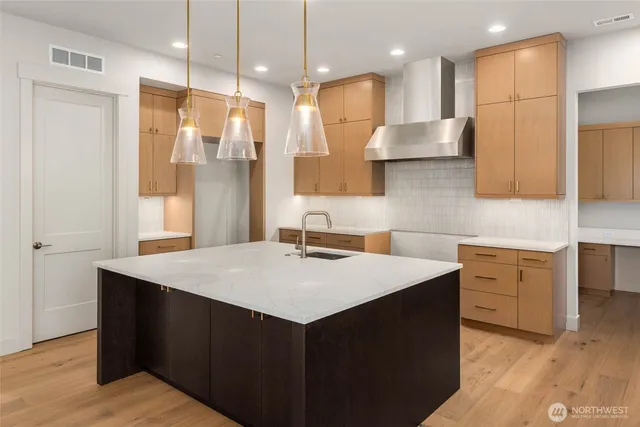 a bathroom with a sink a large mirror and a shower
