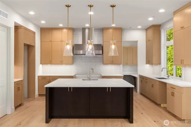 a kitchen with a stove a refrigerator a sink and a kitchen island