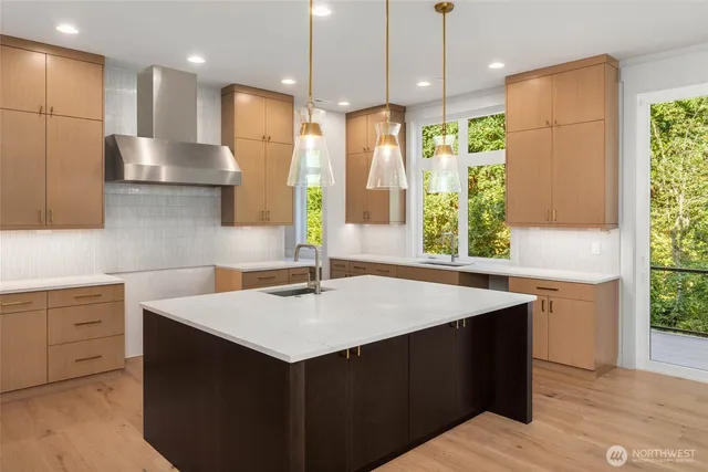 a kitchen that has a sink and a large window