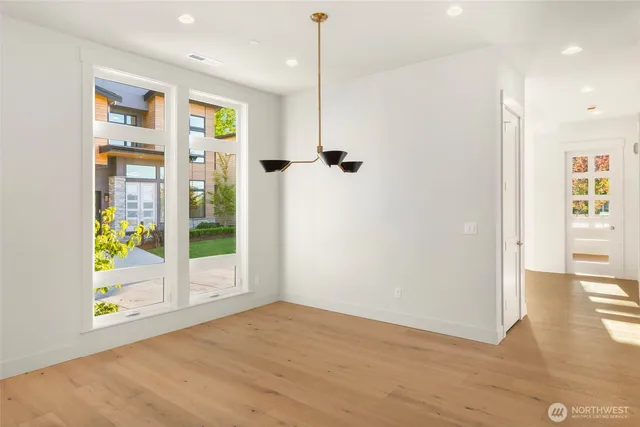 a view of empty room with wooden floor and fireplace