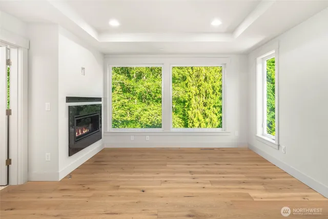 a view of empty room with window and fireplace