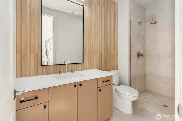 a kitchen with wooden cabinets and a wooden floor
