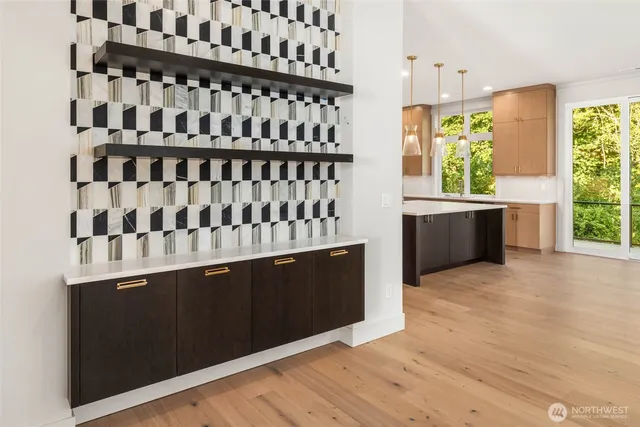 a kitchen that has a sink a refrigerator and a stove in it