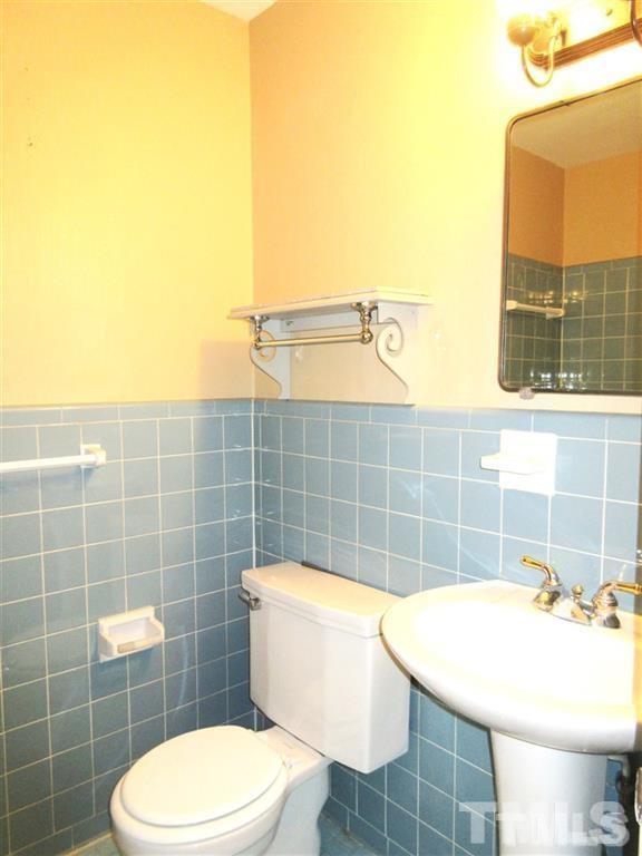 2729 Rothgeb Drive Raleigh, NC 27609 - Photo 11 of 14 a bathroom with a sink a toilet and a mirror