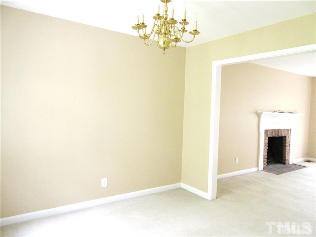 2729 Rothgeb Drive Raleigh, NC 27609 - Photo 6 of 14 a view of a chandelier fan and fire place