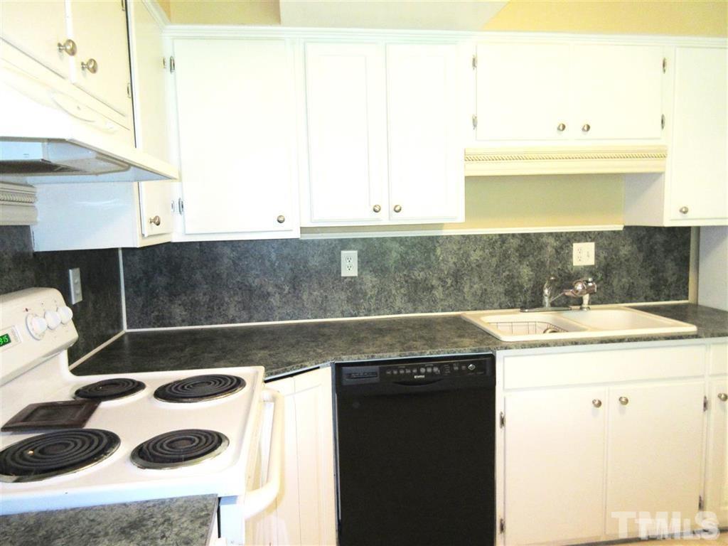 2729 Rothgeb Drive Raleigh, NC 27609 - Photo 7 of 14 a kitchen with a sink a stove and a microwave