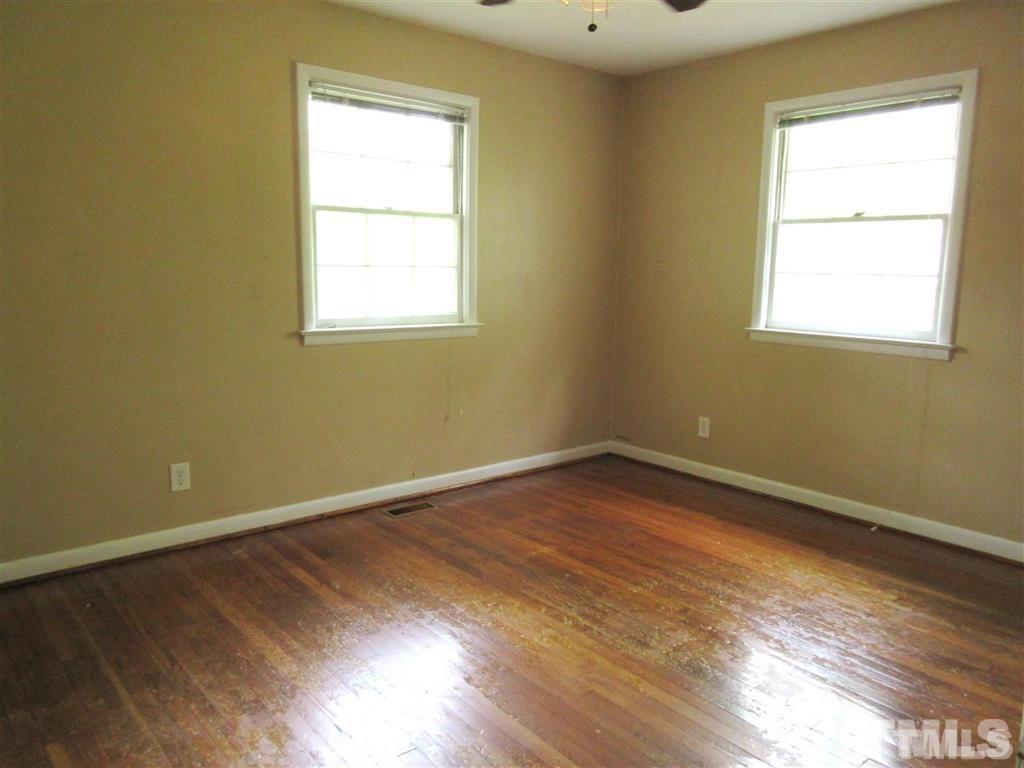 2729 Rothgeb Drive Raleigh, NC 27609 - Photo 10 of 14 a view of an empty room with wooden floor and a window