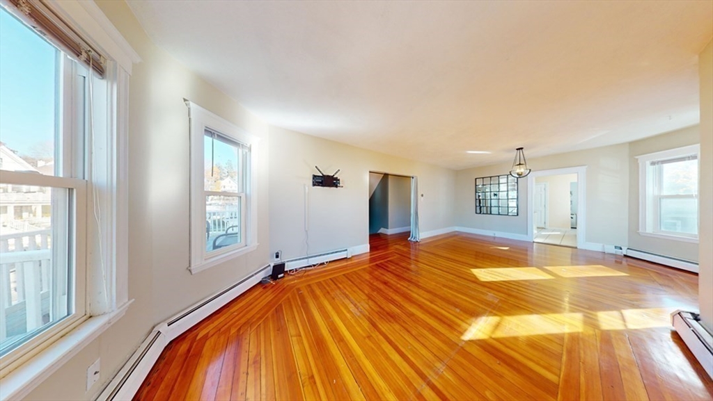 17 Gorham Road, Unit 2 Medford, MA 02155 - Photo 9 of 37 a bed sitting in a spacious bedroom next to a window