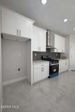 a view of kitchen with kitchen island stainless steel appliances a table and chairs in it