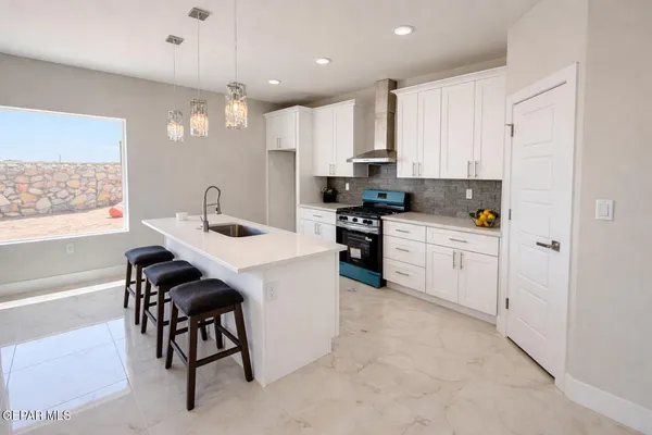 a kitchen with white cabinets