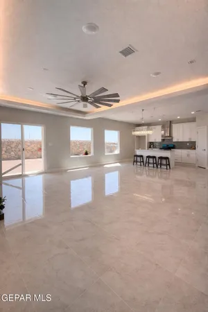 a view of a dining room with furniture and a chandelier fan