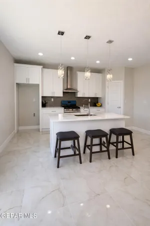 a kitchen with kitchen island granite countertop a sink and dishwasher