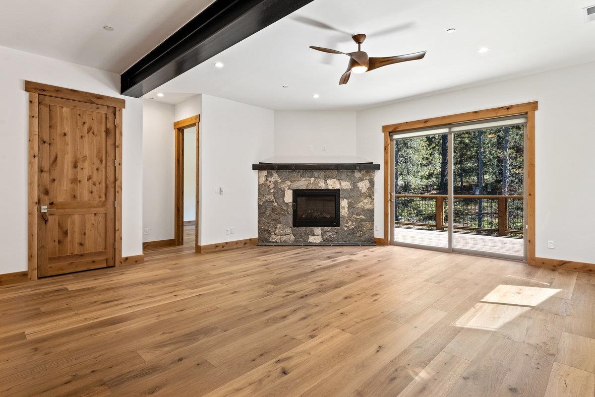 a view of an empty room with a fireplace and a window