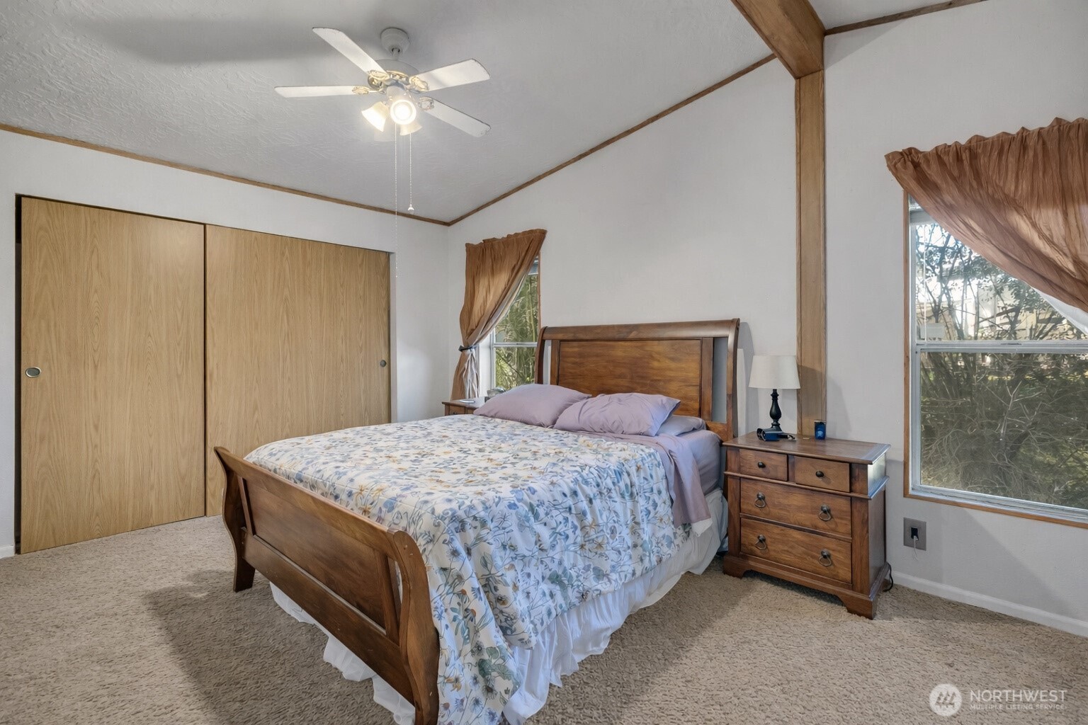 1507 286th Street East Roy, WA 98580 - Photo 12 of 22 a bedroom with a bed and a chandelier