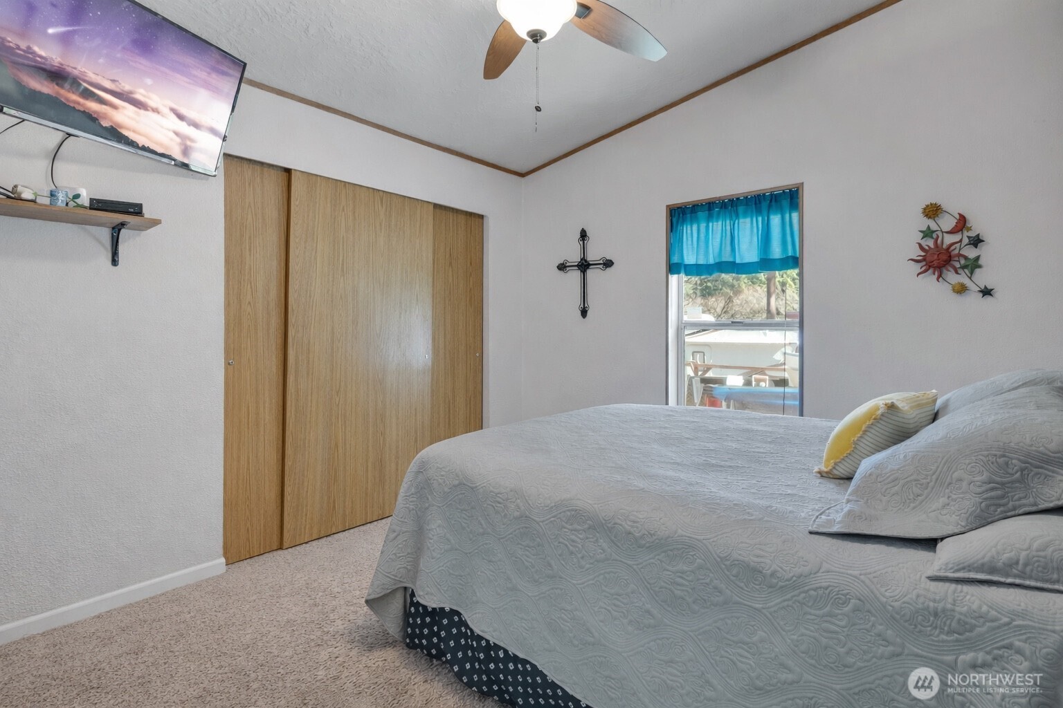 1507 286th Street East Roy, WA 98580 - Photo 15 of 22 a bedroom with a bed and a chandelier