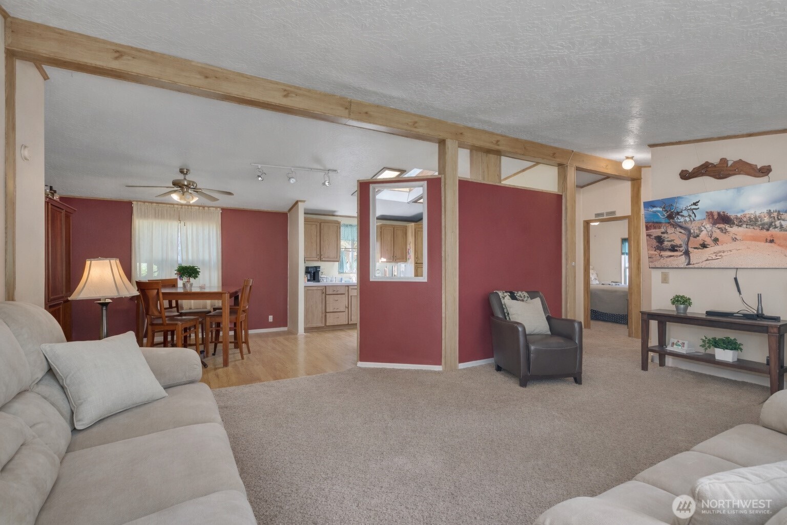 1507 286th Street East Roy, WA 98580 - Photo 6 of 22 a living room with furniture and a dining table with kitchen view