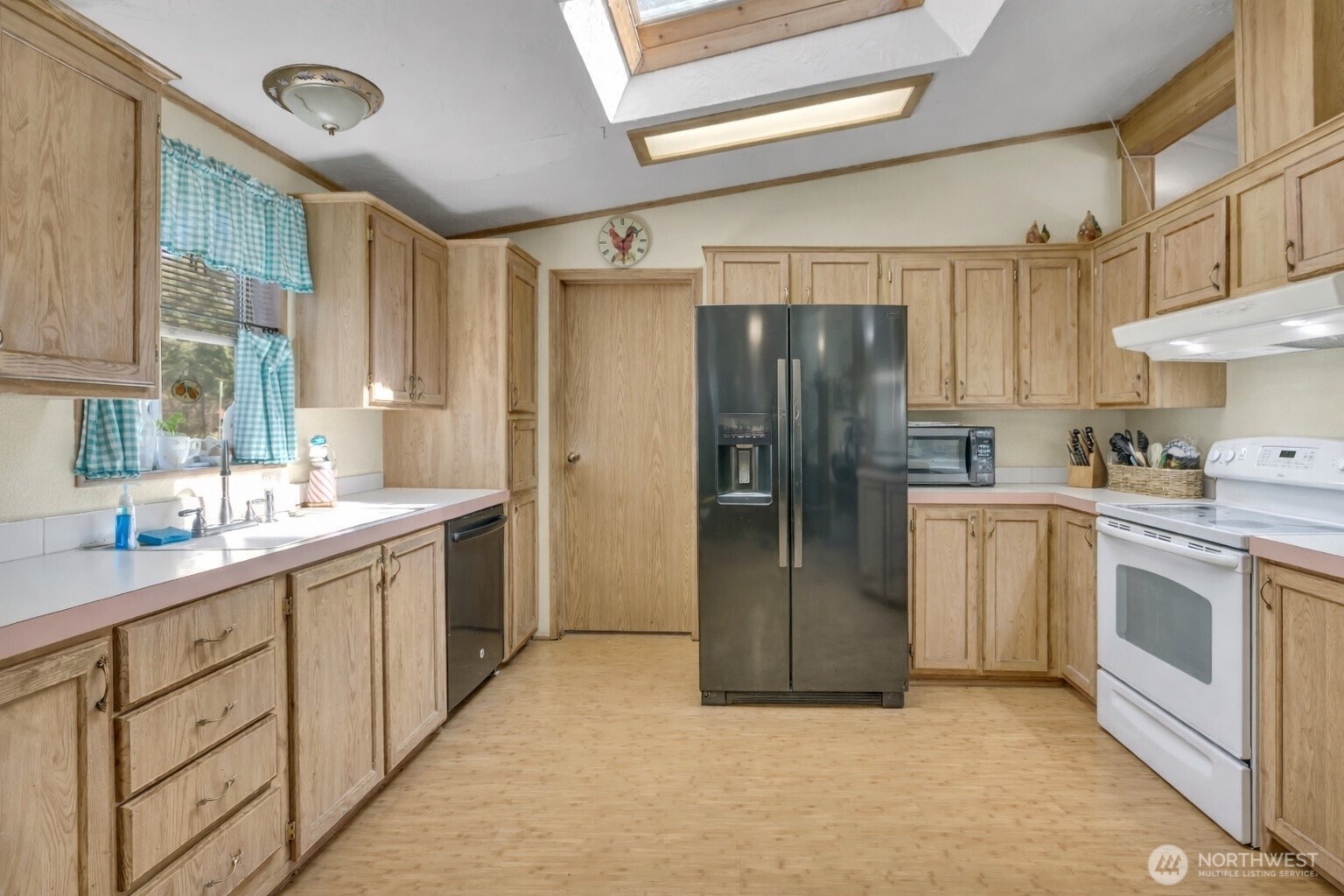1507 286th Street East Roy, WA 98580 - Photo 7 of 22 a kitchen with stainless steel appliances a refrigerator sink and cabinets