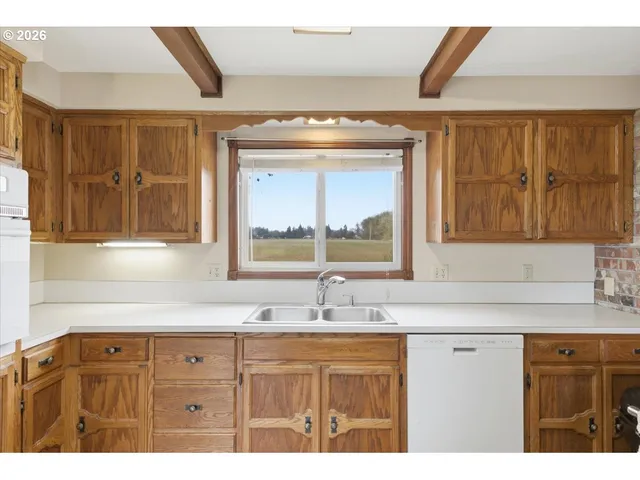 a sink with a granite countertop window