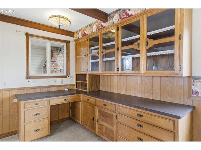 a kitchen with a sink and a large window