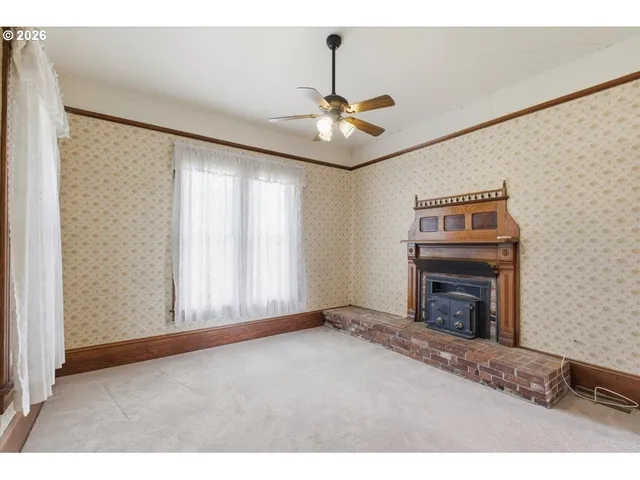 a view of empty room with fireplace