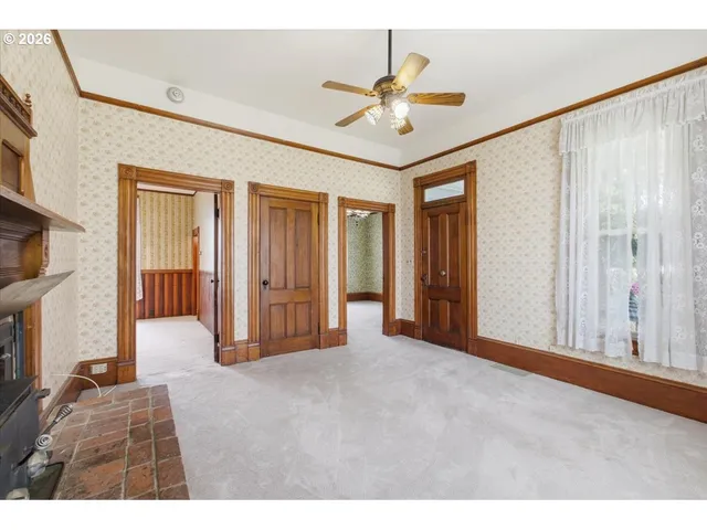 a view of an empty room with a ceiling fan