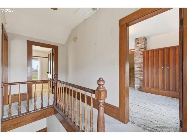 a view of hallway with wooden floor